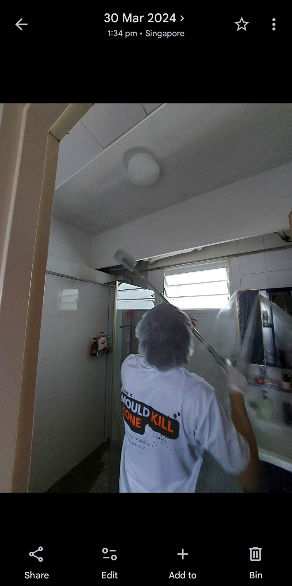 Pico X Health technician treats bathroom ceiling with extension tool for thorough mould removal - Singapore HDB