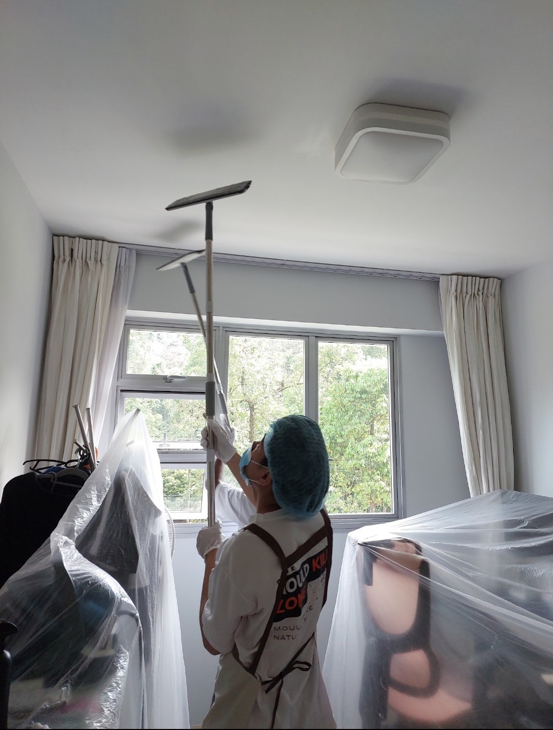Pico X Health technician uses professional ceiling sander for mould removal with protective floor sheeting - Singapore condo